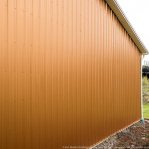 Copper Penny ABM Panel Sides and Clay Roof at School