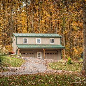 2-story Garage in the woods with Textured Evergreen ABM Panel and Clay