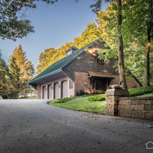 Brick Garage with Green Metal Roof in the Woods